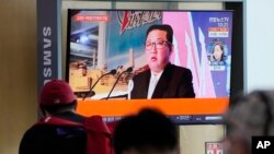 FILE - People watch a TV screen showing an image of North Korean leader Kim Jong Un during a news program at the Seoul Railway Station in Seoul, South Korea, Oct. 12, 2021. 