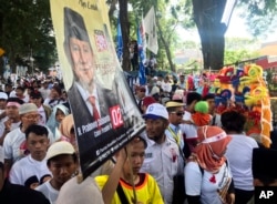 Supporters hold a banner showing support for presidential candidate Prabowo Subianto during a campaign rally in Tangerang, Indonesia, April 13, 2019.