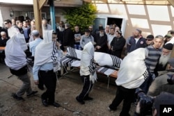 Israelis carry the body of Raziel Shevah during his funeral in Havat Gilad, an unauthorized Israeli settlement outpost near the Palestinian city of Nablus, Jan. 10, 2018.