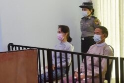 FILE - This handout photo taken May 24, 2021, and released by Myanmar's Ministry of Information May 26, shows detained civilian leader Aung San Suu Kyi (L) and detained president Win Myint (R) during their first court appearance in Naypyidaw.