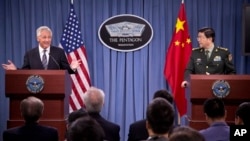 Defense Secretary Chuck Hagel gestures during a joint news conference with Chinese Minister of Defense Gen. Chang Wanquan at the Pentagon, Aug. 19, 2013.