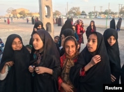 FILE - Afghan refugee girls gather at the Bardsir settlement for Afghan refugees in Kerman province, Iran, Oct. 22, 2016.