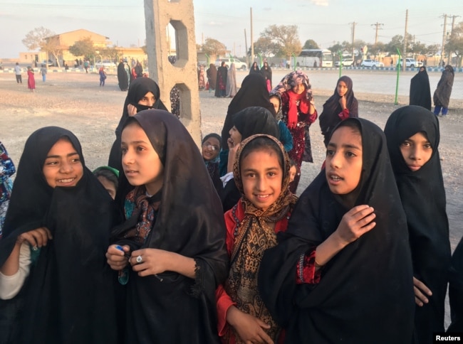 FILE - Afghan refugee girls gather at the Bardsir settlement for Afghan refugees in Kerman province, Iran, Oct. 22, 2016.