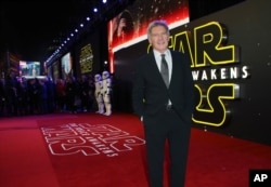 FILE - Harrison Ford poses for photographers upon arrival at the European premiere of the film 'Star Wars: The Force Awakens ' in London, Dec. 16, 2015.