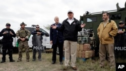 President Donald Trump speaks as tours the U.S. border with Mexico at the Rio Grande on the southern border, Thursday, Jan. 10, 2019, in McAllen, Texas, as Sen. John Cornyn, R-Texas, left, and Sen. Ted Cruz, R-Texas, listen.