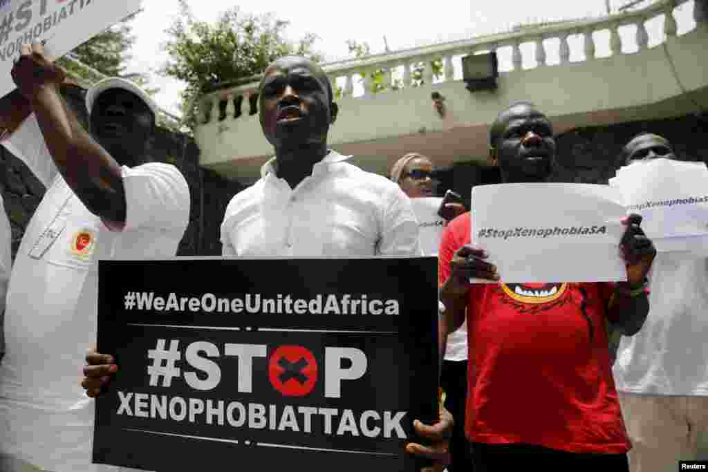 People protesting against xenophobia in South Africa hold placards in front of the South African consulate in Lagos, April 16, 2015. 