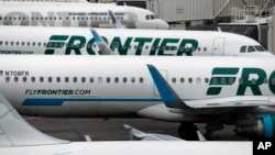 FILE - In this May 15, 2017, photo, Frontier Airlines jetliners sit at Denver International Airport in Denver.