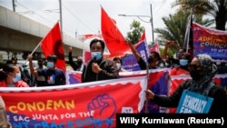 Activists hold placards and banners during a protest to support the anti-coup movement and democracy in Myanmar, near the Association of Southeast Asian Nations (ASEAN) secretariat building, ahead of the ASEAN leaders' meeting in Jakarta, Indonesia April 