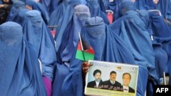 Burqa-clad Afghan women attend an election rally of Afghan presidential candidate Gul Agha Shirzai in Jalalabad, Nangarhar province, March 8, 2014.