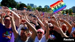 Supporters of the 'Yes' vote for marriage equality celebrate after it was announced the majority of Australians support same-sex marriage in a national survey, paving the way for legislation to make the country the 26th nation to formalize the unions by t