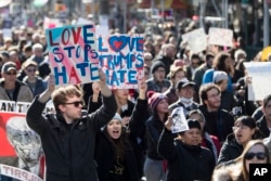 Demonstrators march up 5th Avenue during a protest against the election of President-elect Donald Trump, Nov. 12, 2016, in New York.