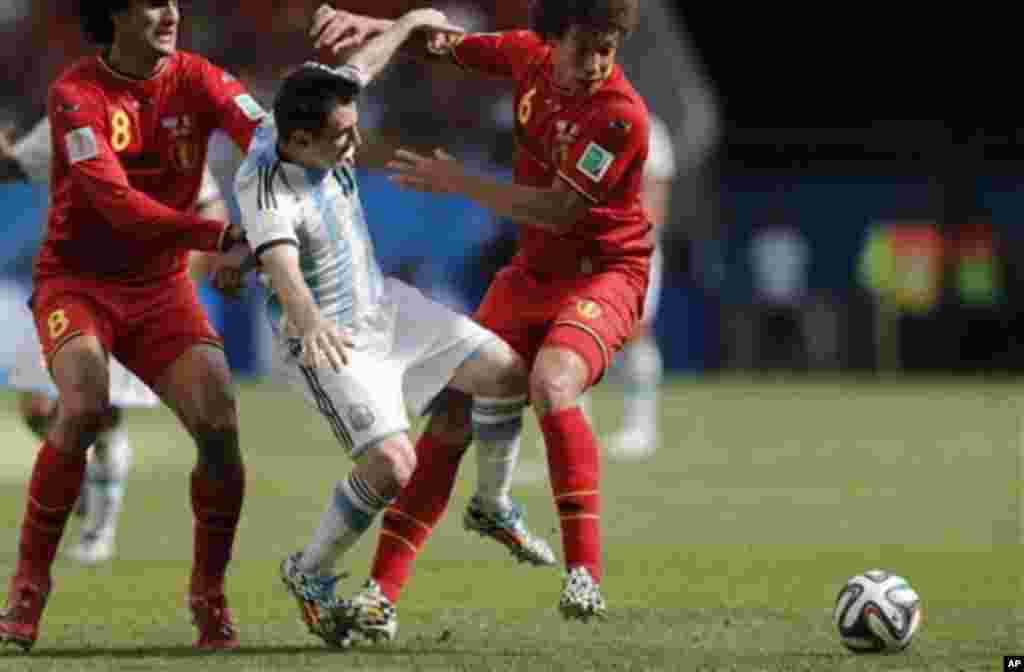 Argentina's Lionel Messi fights for the ball with Belgium's Marouane Fellaini, left, and Axel Witsel during the World Cup quarterfinal soccer match between Argentina and Belgium at the Estadio Nacional in Brasilia, Brazil, Saturday, July 5, 2014. (AP Phot