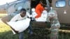 Workers offload food aid from a South African National Defence Force helicopter in the aftermath of Cyclone Idai in Buzi, near Beira, Mozambique, March 25, 2019.