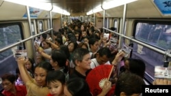 Commuters ride a train during rush hour on Southeast Asia's first light rail transit network, which is 29-years-old, in Manila, Oct. 10, 2013. The Philippines is about to spend $169 billion on infrastructure, including railways and an airport terminal.