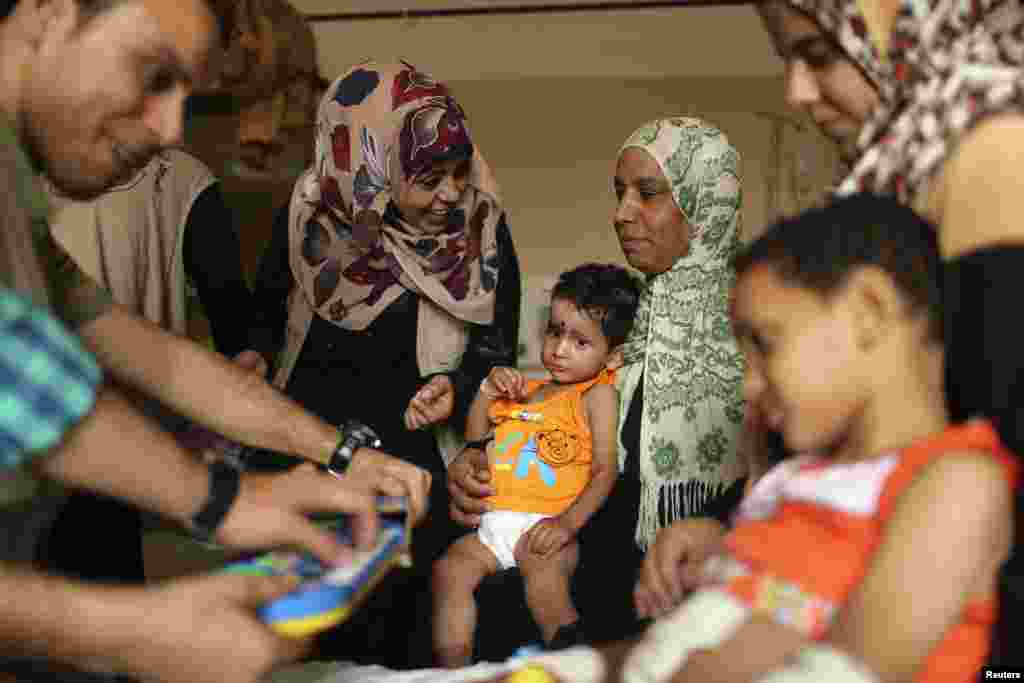 Mohammed Wahdan, wounded in Israeli shelling, receives psychological care at Shifa hospital in Gaza City, Aug. 14, 2014.