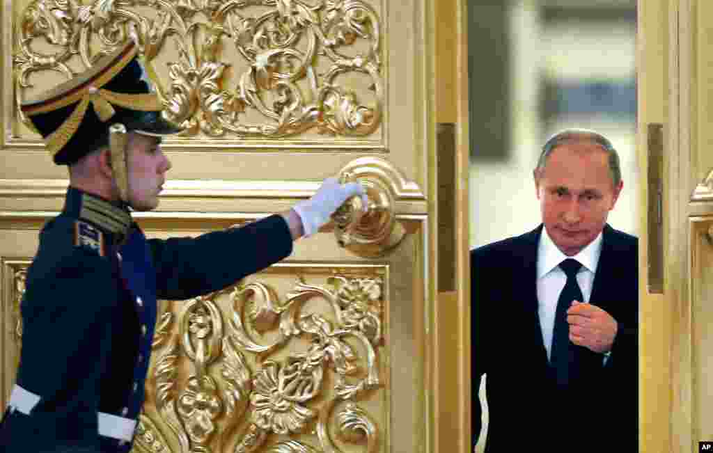 Russian President Vladimir Putin enters the Alexadrovsky Hall to head a meeting of the Presidential Council for Civil Society and Human Rights at the Kremlin in Moscow, Russia.