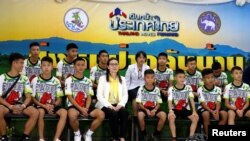 The 12 boys and their soccer coach who were rescued from a flooded cave arrive for a news conference in the northern province of Chiang Rai, Thailand, July 18, 2018. 