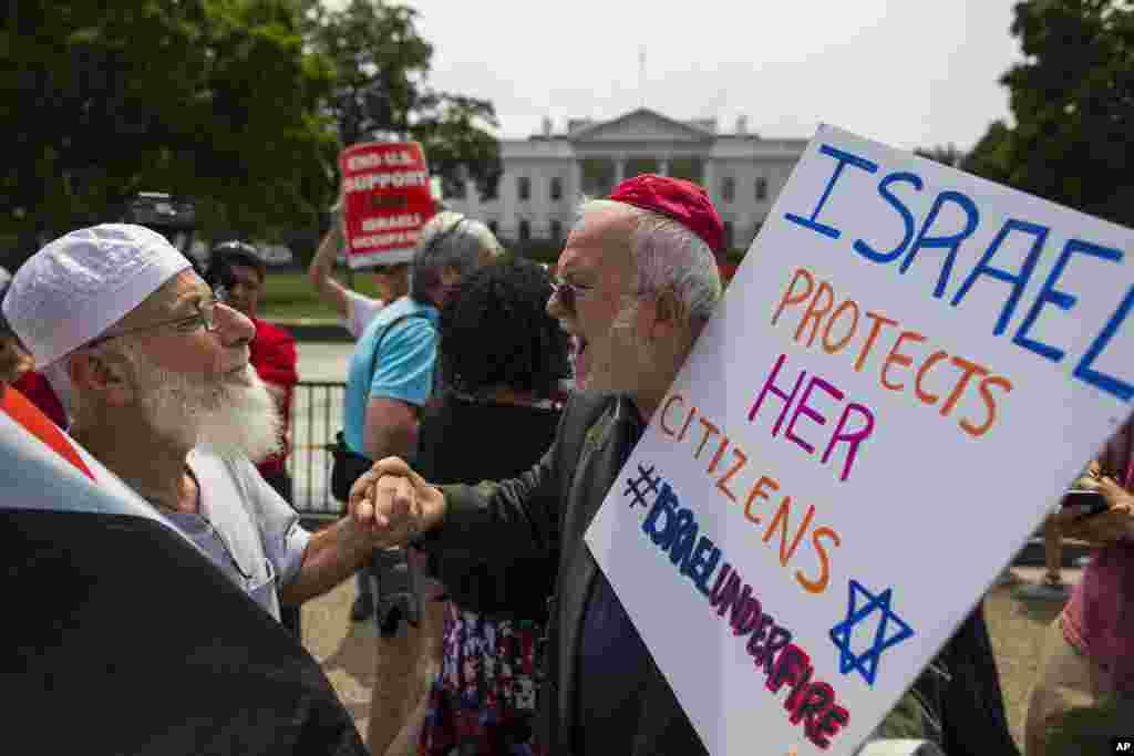 Samir Hineidi, of Fairfax, Virginia, left, and a demonstrator who chose not to be identified, participate in a Middle East demonstration outside the White House in Washington.