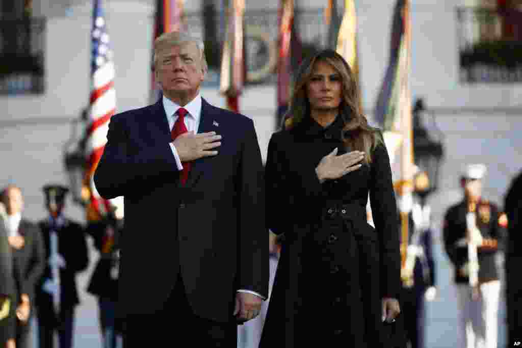 President Donald Trump and first lady Melania Trump stand for a moment of silence to mark the anniversary of the Sept. 11 terrorist attacks, on the South Lawn of the White House in Washington, Sept. 11, 2017.