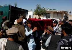 FILE - Relatives carry the coffin of one of the victims a day after an attack on an army headquarters in Mazar-i-Sharif, northern Afghanistan, April 22, 2017.