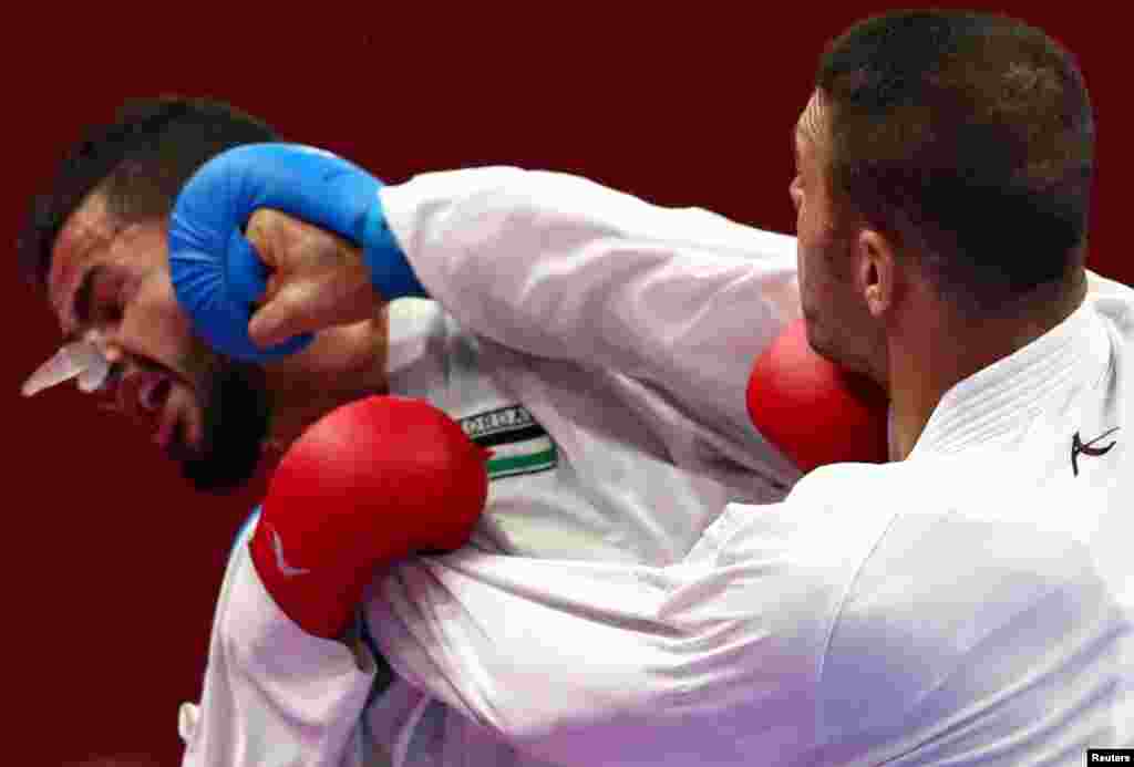 Mahmoud Sajan of Jordan competes against Zniollah Poorshab of Iran during the men&#39;s-84kg karate match at the 2018 Asian Games in Jakarta, Indonesia.