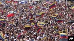 Concert goers unfurl their Venezuelan flags during the Venezuela Aid Live concert on the Colombian side of the Tienditas International Bridge near Cucuta, Colombia, on the border with Venezuela, Feb. 22, 2019. 