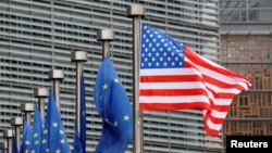 FILE - A U.S. and European Union flags are pictured during the visit of Vice President Mike Pence to European Commission headquarters in Brussels, Belgium, Feb. 20, 2017.
