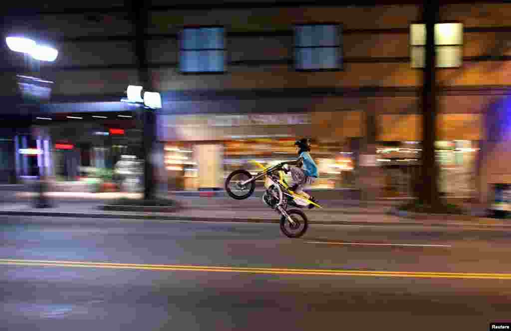 A young man rides a motorbike in Charlotte, North Carolina, Sept. 25, 2016, as demonstrators there continue&nbsp;to protest the police shooting of Keith Scott.