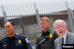 U.S. Attorney General Jeff Sessions holds a news conference next to the U.S. Mexico border wall to discuss immigration enforcement actions of the Trump Administration near San Diego, California, May 7, 2018.
