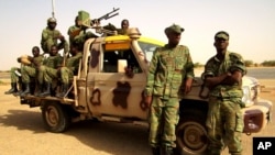 Soldiers from Burkina Faso stand guard at the airport, in Timbuktu, Mali, May 22, 2013.