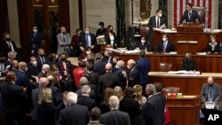 In this image from House Television, House Speaker Nancy Pelosi joins other Democratic members on the House floor late Nov. 5, 2021, in Washington, as the House approves a $1 trillion infrastructure package.