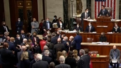 In this image from House Television, House Speaker Nancy Pelosi joins other Democratic members on the House floor late Nov. 5, 2021, in Washington, as the House approves a $1 trillion infrastructure package.