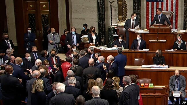 In this image from House Television, House Speaker Nancy Pelosi joins other Democratic members on the House floor late Nov. 5, 2021, in Washington, as the House approves a $1 trillion infrastructure package.