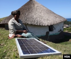 Nozethile Nkwaza powers her shebeen with a solar panel, and declares herself in favor of the radical anti-alcohol law (D. Taylor/VOA)
