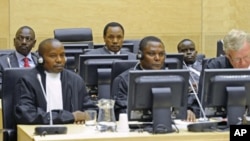 Three Kenyan suspects (back row, from L to R), William Ruto (L), Henry Kosgey (C) and Joshua Arap Sang (R), accused of crimes against humanity in their country's post-election violence in 2007-08, make their initial appearance at the International Crimina