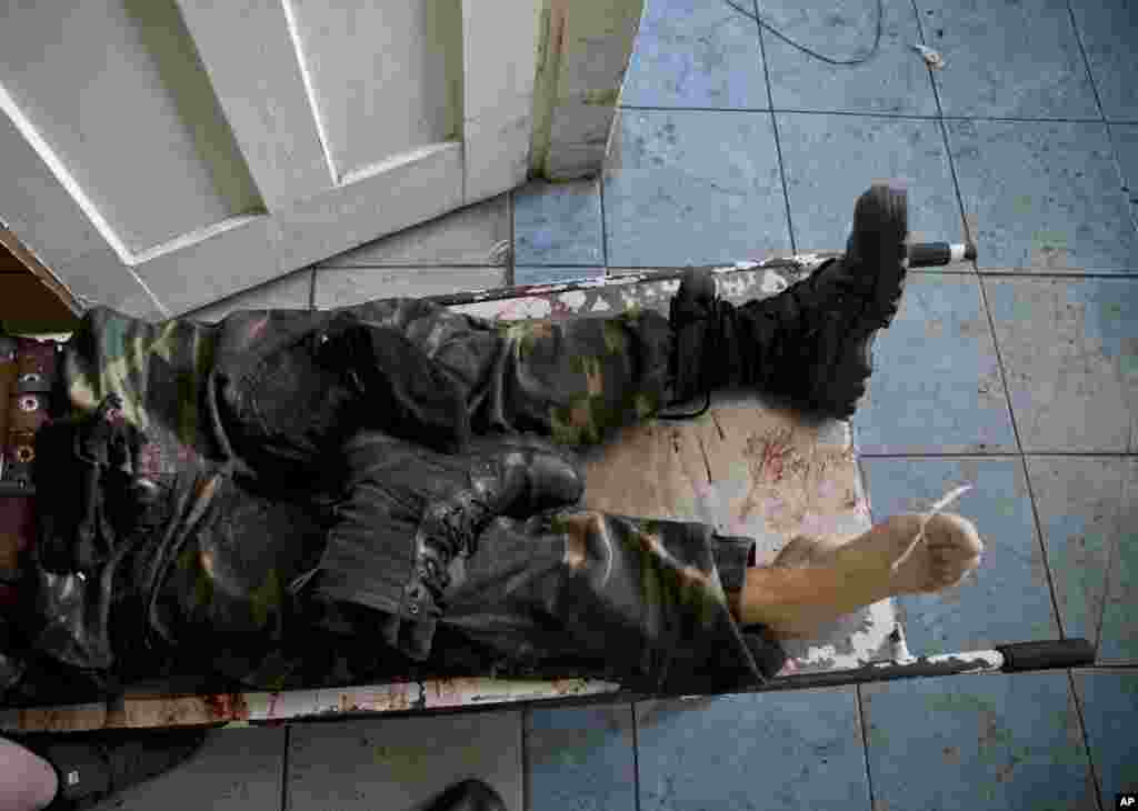 The body of a pro-Russian gunman killed in clashes with Ukrainian government forces around the airport lies on a stretcher at a city morgue in Donetsk, May 27, 2014.