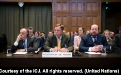 FILE - The Agents of the Russian Federation, Roman A. Kolodkin, Ilya Rogachev and Grigory Lukiyantsev, attend the opening day of hearings at the International Court of Justice in The Hague, March 6, 2017.