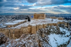 Bukit Acropolis kuno di Athena, Yunani, berselimut salju, Rabu, 17 Februari 2021.