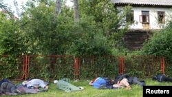 Migrants sleep in a park after a migrant camp burned in Velika Kladusa, Bosnia and Herzegovina 