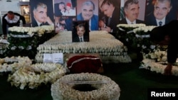 FILE - Wreaths and pictures of Lebanon's former Prime Minister Rafik al-Hariri are seen at his gravesite in downtown Beirut, Feb. 14, 2013. 