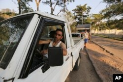 In this Feb. 13, 2019 photo, Luis Gonzalez waits to fill up at a gas station in San Cristobal, Venezuela.