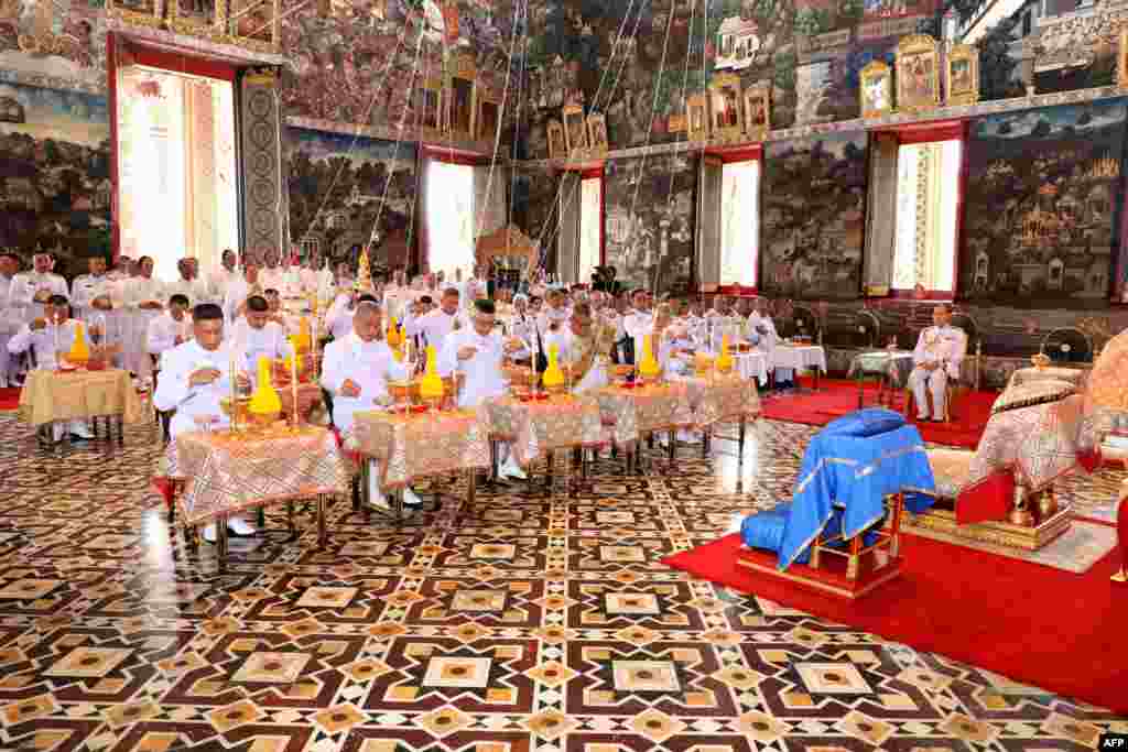 Royal astrologers and members of the Royal Thai court participate in a ritual ahead of the coronation to inscribe Thai King Maha Vajiralongkorn's name and title, cast the king's horoscope, and engrave the king's official seal at the Wat Phra Kaew, or the Temple of the Emerald Buddha, in Bangkok, Thailand.