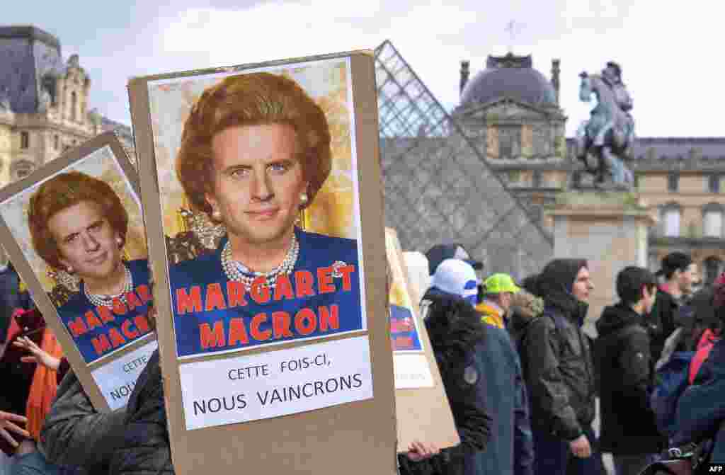 Protesters hold placards reading &quot;Maragaret Macron, this time we will win&quot; under a photomontage of late British Prime Minister Margaret Thatcher and French President Emmanuel Macron as they demonstrate in front of the Louvre Museum in Paris as part of a multi-sector strike against the French government&#39;s pensions overhaul.