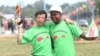 An unidentfied Chinese national and a Zimbabwean man hug while welcoming Chinese President Xi Jinping upon his arrival in Harare, Zimbabwe, Tuesday, Dec. 1. 2015. Jinping is in Zimbabwe for a two day State visit during which he is set to sign some bilateral agreements aimed at strengthening relationships between the two countries. (AP Photo/Tsvangirayi Mukwazhi)