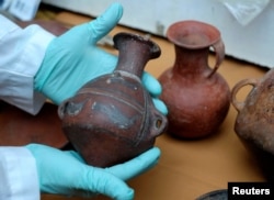 Ceramic pieces are displayed as part of an archeological finding, dated approximately 500 years ago in Mazo Cruz, near Viacha, Bolivia, Nov. 12, 2018.