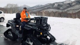 Masami Yashima, manager of Okushiga Kogen snow resort, sits on a snow quad in a parking lot in the winter season in Nagano, Japan, on January 25, 2020. (Reuters/Aaron Sheldrick)