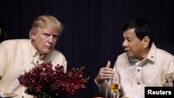 U.S. President Donald Trump talks with Philippines President Rodrigo Duterte during the gala dinner marking ASEAN's 50th anniversary in Manila, Philippines, Nov. 12, 2017.