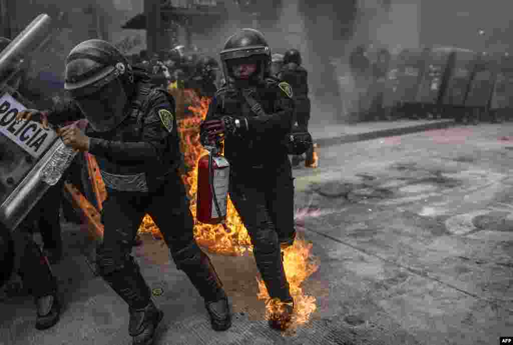 Supporters of the legalization of abortion clash with riot police during a demonstration in the framework of the International Safe Abortion Day, in Mexico City, Sept. 28, 2020.