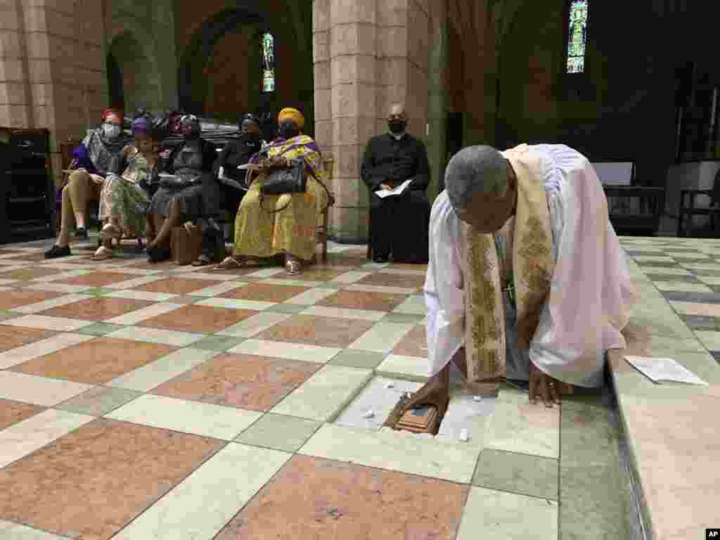 In this photo provided by Oryx Media, Anglican Archbishop Thabo Makgoba lays the ashes of Archbishop Emeritus Desmond Tutu to rest at the high altar of St. George&#39;s Cathedral, in Cape Town, South Africa.