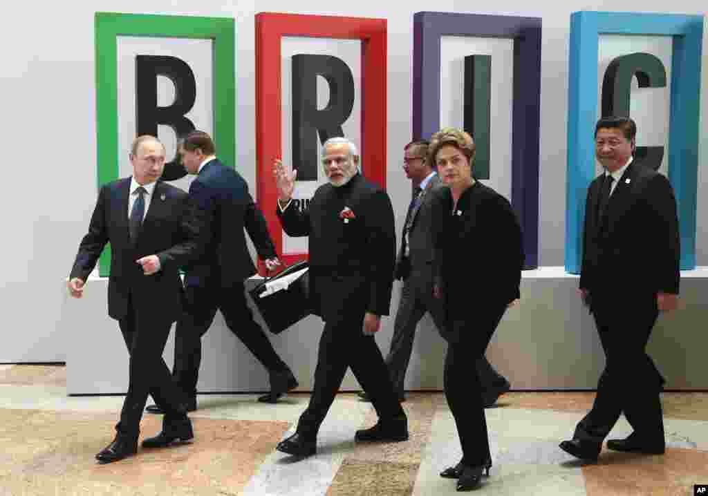 From left in front row: Russian President Vladimir Putin, Indian Prime Minister Narendra Modi, Brazilian President Dilma Rousseff, Chinese President Xi Jinping walk for a plenary session during the summit in Ufa, Russia, Thursday, July 9, 2015.